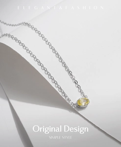 Macro detail of elegant s925 silver necklace with oval yellow faceted gemstone pendant