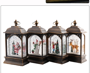 Detail view of four bronze Christmas water lanterns featuring Santa and snowman scenes
