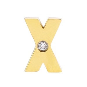 Macro detail of golden stainless steel X-shaped pendant with a sparkling crystal center