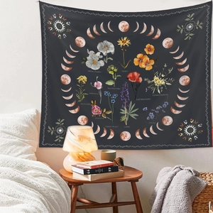 Close-up of bohemian floral tapestry featuring moon phases and vintage botanical motifs