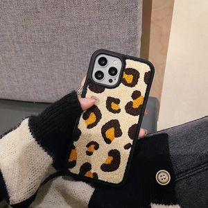 Close-up of plush leopard print iPhone case featuring soft embroidered faux fur texture