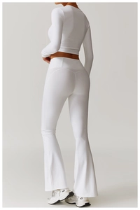 Macro shot of white long sleeve crop top and high waist flared yoga leggings set