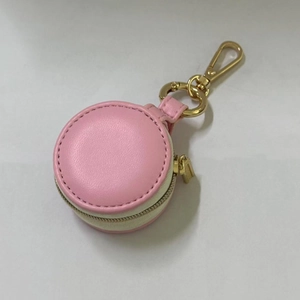 Close-up of pink and white mini jewelry box pendant with golden zipper and lobster clasp