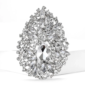 Close-up of sparkling silver alloy brooch with large oval crystal and marquise rhinestones