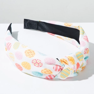Detailed close-up of knot structure and Easter egg patterns on the wide fabric headband