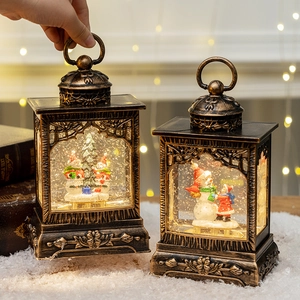 Vintage bronze Christmas lantern with illuminated snow scene and swirling glitter