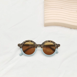 Detailed top view of leopard print and light blue round frame kids sunglasses with UV400 lenses
