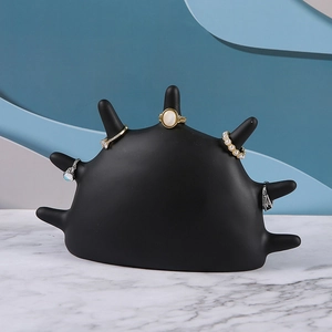 Nordic resin hand shaped jewelry tray with multiple ring display stands on marble