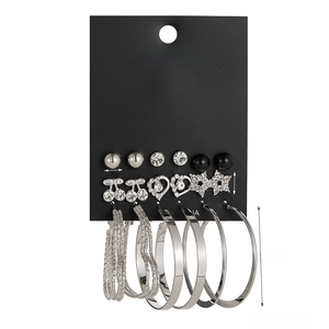 Detail view of 9-pair silver geometric earring set with cherry and heart motifs