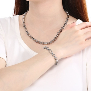 Detail view of silver titanium steel oval link necklace and bracelet set for men and women