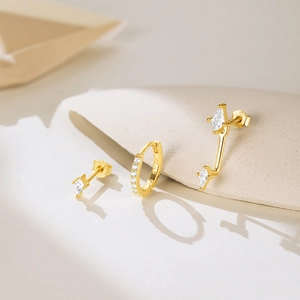 Detailed macro view of gold-plated S925 silver earrings set with white zircon stones