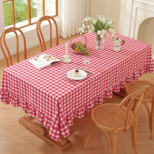 Close-up of red and white checkered rectangle tablecloth with elegant ruffled edges