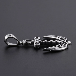 Macro side view of polished stainless steel anchor pendant showing thickness and 3D detail