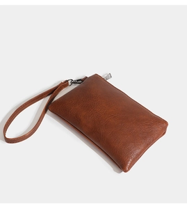 Detail of brown litchi pattern PU leather long wallet with wrist strap and zipper closure