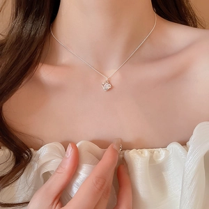 Close-up of 18k gold plated hollow square pendant necklace with sparkling zircon stone