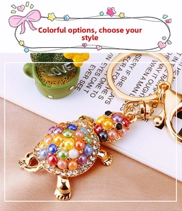 Macro detail of golden turtle keychain with colorful beads and sparkling rhinestones