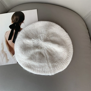 Chic beige mohair knit beret for women with textured wool finish on a grey surface