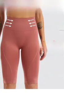Detailed view of high waist pink seamless yoga shorts with rib compression for tummy control