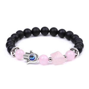 Detail of beaded bracelet featuring Hamsa Hand, Evil Eye and pink pyramid stone