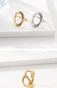 Close-up of gold and silver plated stainless steel rings with artistic hollow shapes