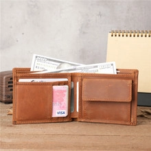 Detail of brown leather wallet with multiple card slots and coin pocket on wooden desk