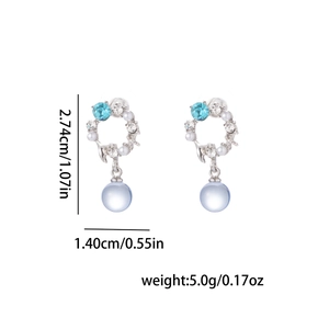 Detailed view of silver mermaid pearl earrings with blue crystals and dimensions 2.74cm