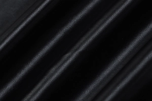 Detailed close-up of premium black PU leather texture with fine grain and soft sheen