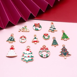 Flat lay of 13 colorful Christmas alloy enamel charms including trees and wreaths