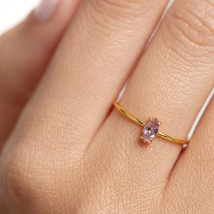 Macro shot of 18k gold plated ring with marquise-cut pink zircon gemstone detail