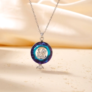 Silver necklace featuring a circular purple crystal pendant with mermaid tail detail