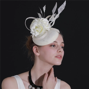 Detail of cream fascinator hat featuring delicate faux flowers and white feathers