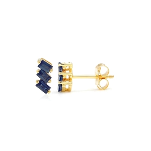 Macro detail of S925 silver earrings with three baguette-cut blue zirconias in gold claws