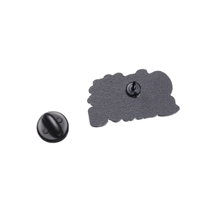Detail of metal pin back with textured surface and black rubber clutch backing accessory