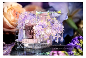Detail of vintage purple PET sticker with gold stamping and floral patterns on glassware