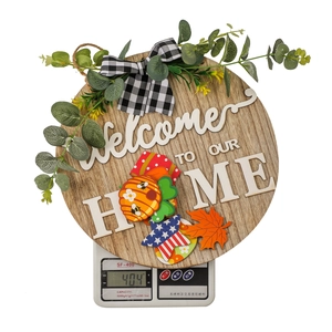 Close-up of wooden Welcome to Our Home sign on scale showing 404g weight details