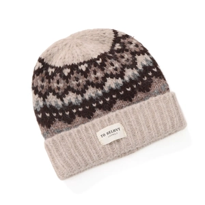 Close-up of Fair Isle knit hat texture with snowflake patterns and ribbed cuff