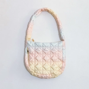 Detail of gradient pink puffy tote bag with quilted pattern and golden zipper closure