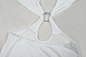 Detail of white halter neck dress with a decorative silver metal ring connector