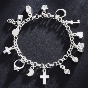Silver multi-charm link bracelet with cross, heart, and star pendants on black background