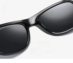 Detailed close-up of integrated nose pads on black glossy retro-style sunglasses