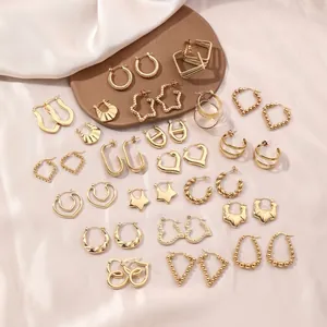 Irregular gold stainless steel earring set with heart and star shapes on silk
