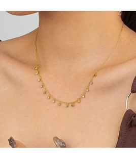 Close-up of gold fringe necklace with colorful zircon pendants on model neck