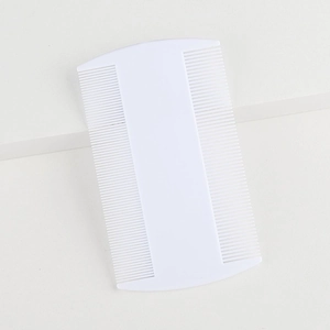 White double-sided fine-tooth flea comb for pets on a minimalist white background