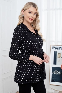 Close-up of women's black hooded jacket with white polka dots and adjustable waist drawstring