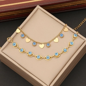 Golden necklace and bracelet set with blue evil eyes and gold heart charms