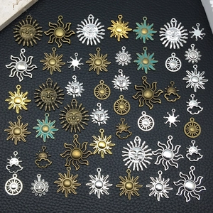 Detailed view of assorted sun and cloud alloy charms in antique silver and bronze finishes