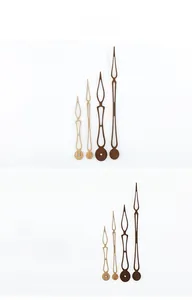 Macro detail of walnut wood clock hands showing natural grain and elegant hollow design