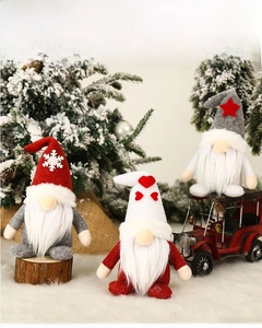 Three plush Christmas gnomes featuring snowflake and star hats on a winter tree background