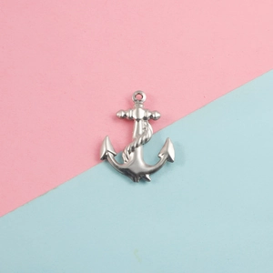 Detailed view of a silver anchor pendant with rope texture on a colorful background