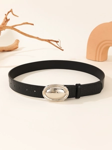 Detail of black crocodile texture leather belt with a polished silver oval metal buckle